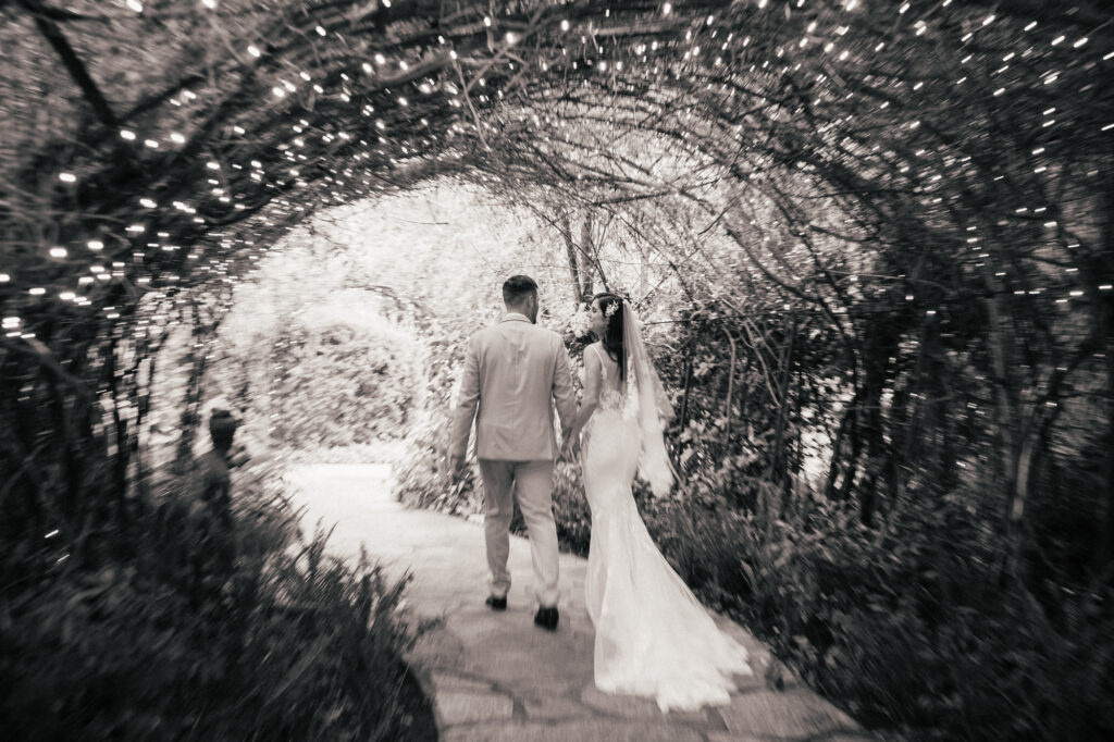 Blurry transitional wedding photo of couple walking at Green Gables Wedding Estate by PMC Photography