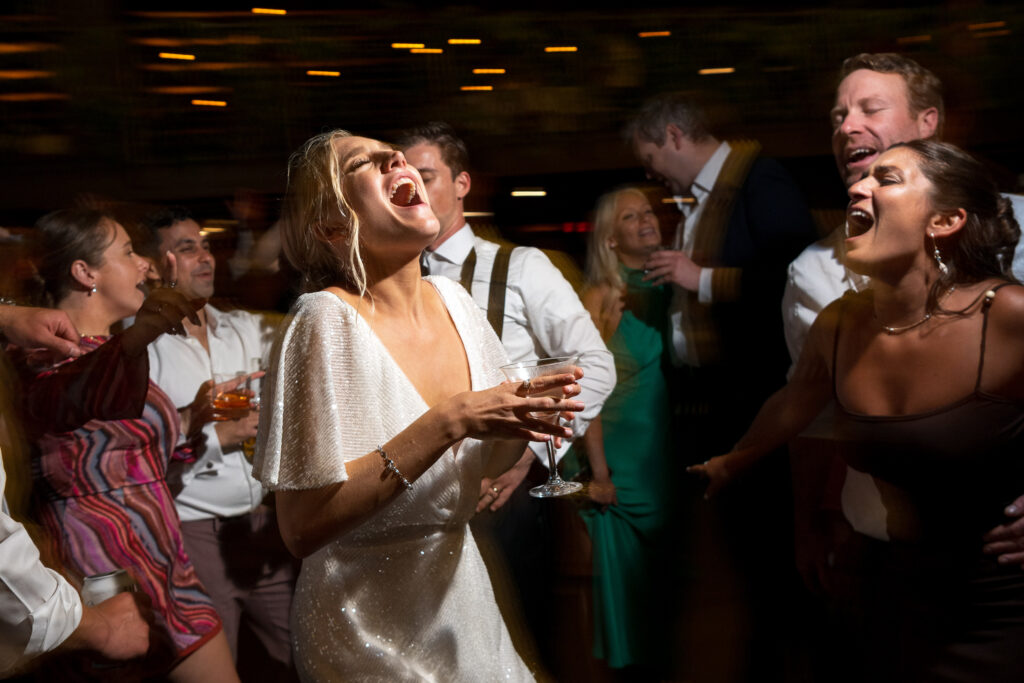 Wedding reception candid moment captured with controlled camera shake conveying spontaneity and energy