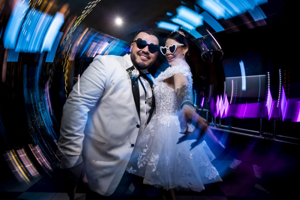 Wedding reception dance floor captured with intentional motion blur conveying energy and movement