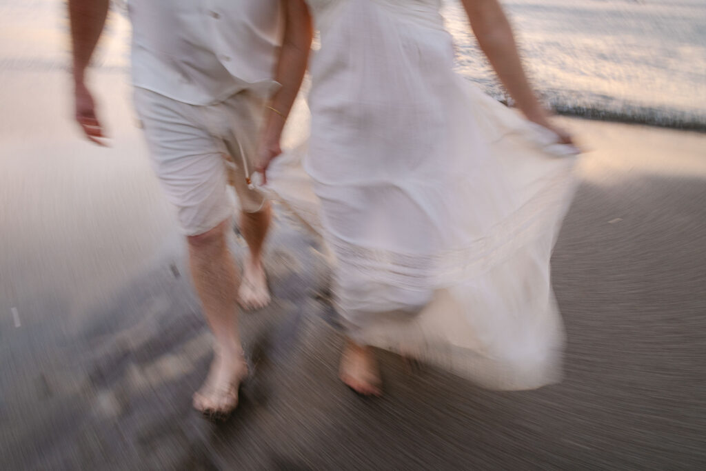 Tight crop of wedding dress fabric and feet in motion with blur and texture by Kevin Heslin Photography